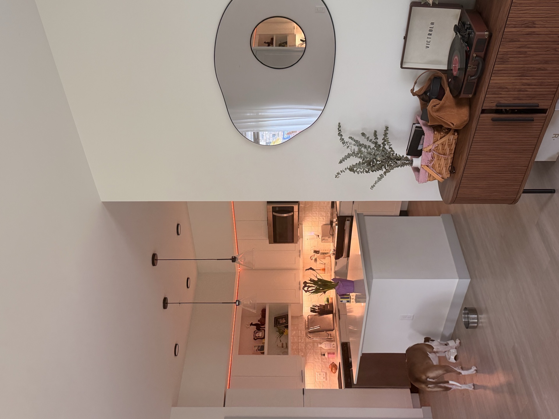 Open living area with record player and kitchen beyond